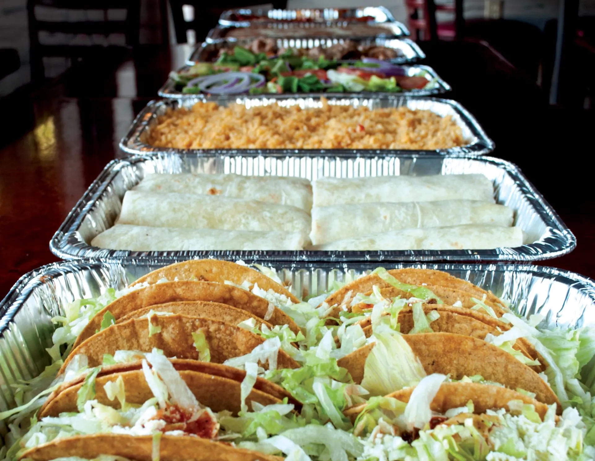 Catering tray: tacos, burritos, rice, beans & salad