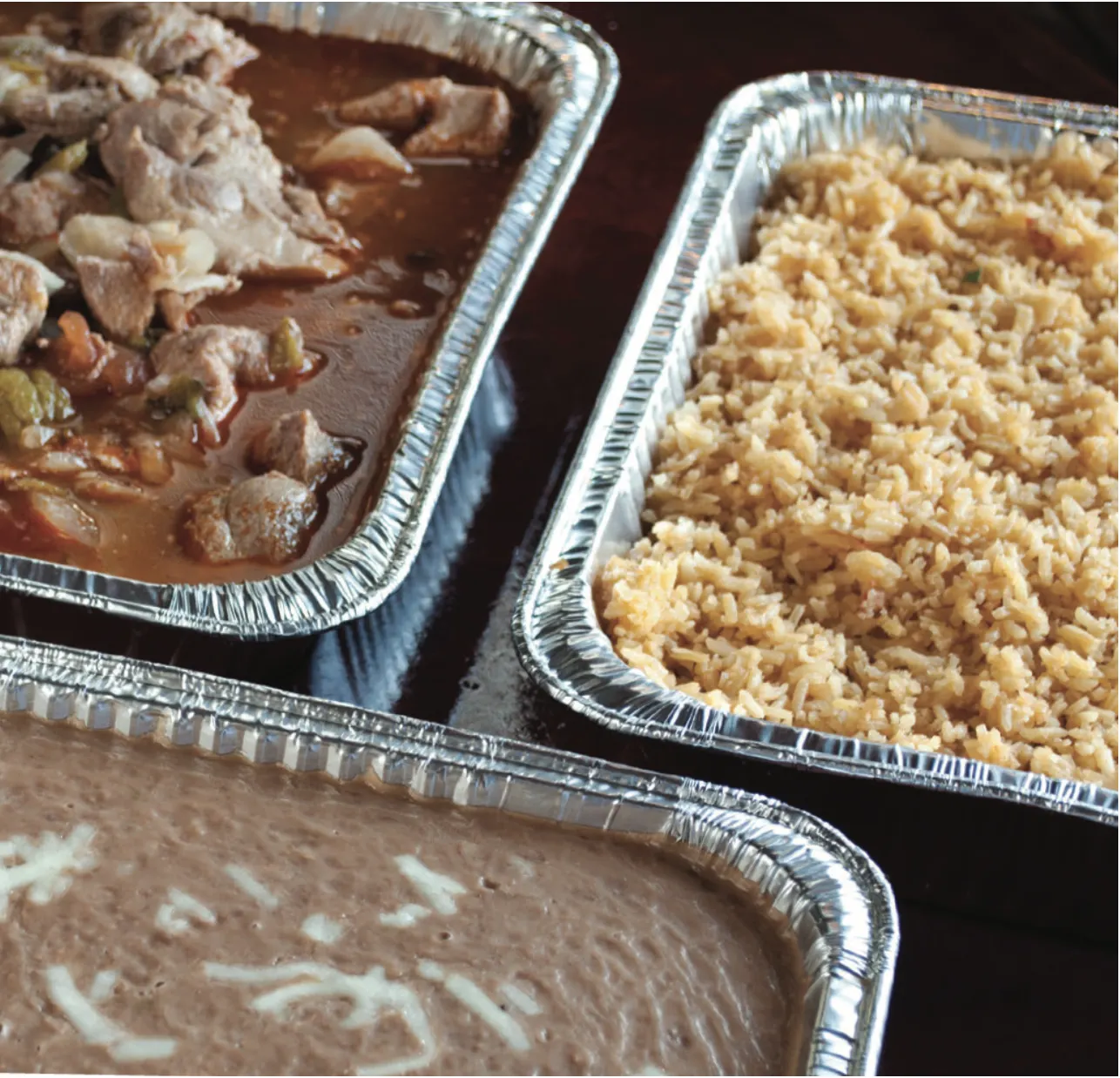 Catering trays: chile verde, Mexican rice and refried beans